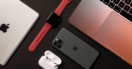 Flat lay of all Apple devices in dark gray background